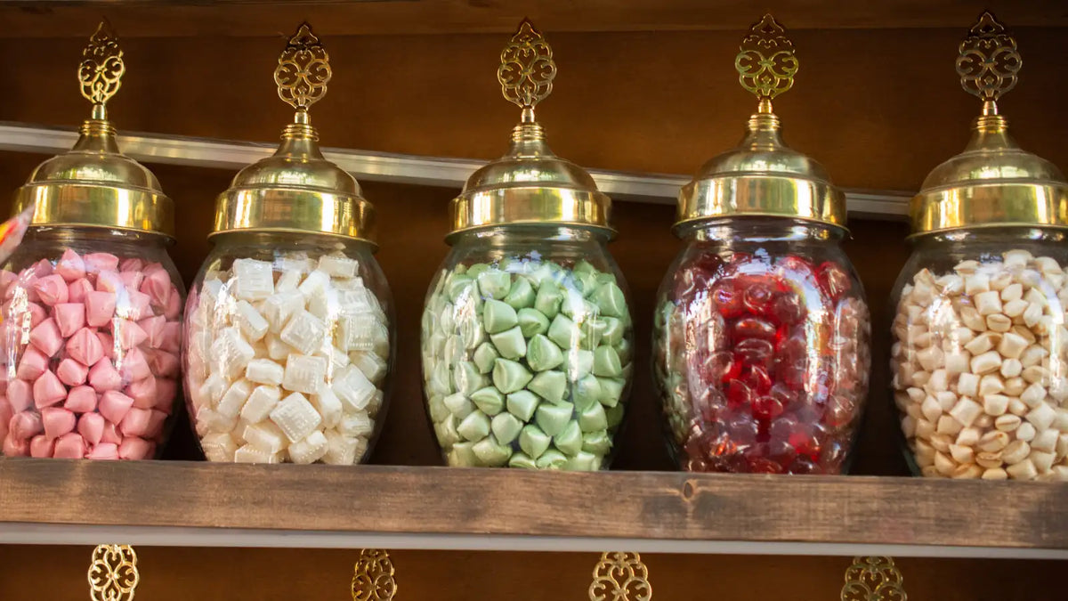 Bonbons de différentes couleurs dans des bocaux en verre pour illustrer des arômes