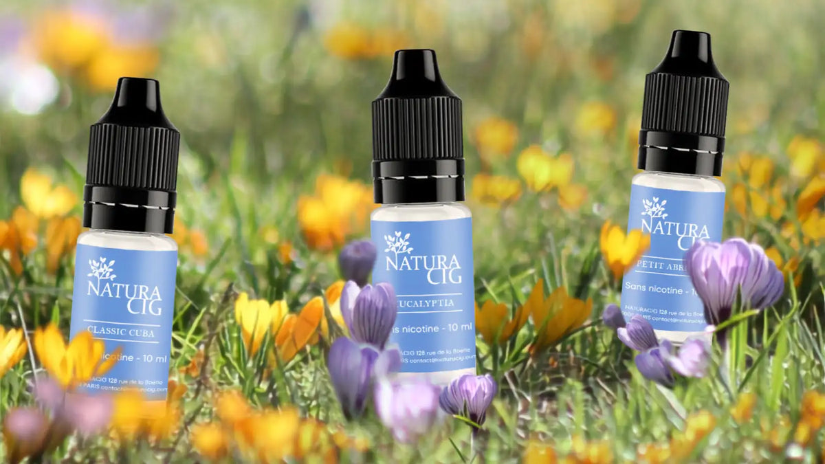 Trois e liquides bio Naturacig présentés dans un décor végétal
